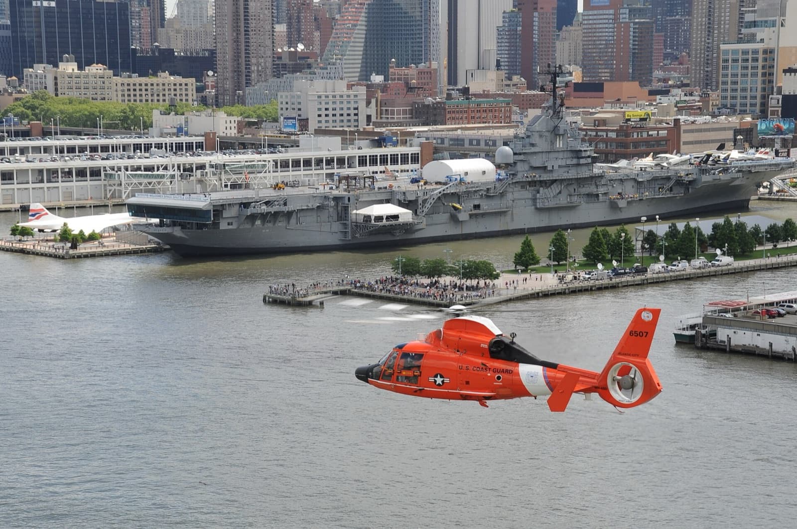 Intrepid Museum: the carrier at Pier 86 from the Hudson, a Coast Guard helicopter passing