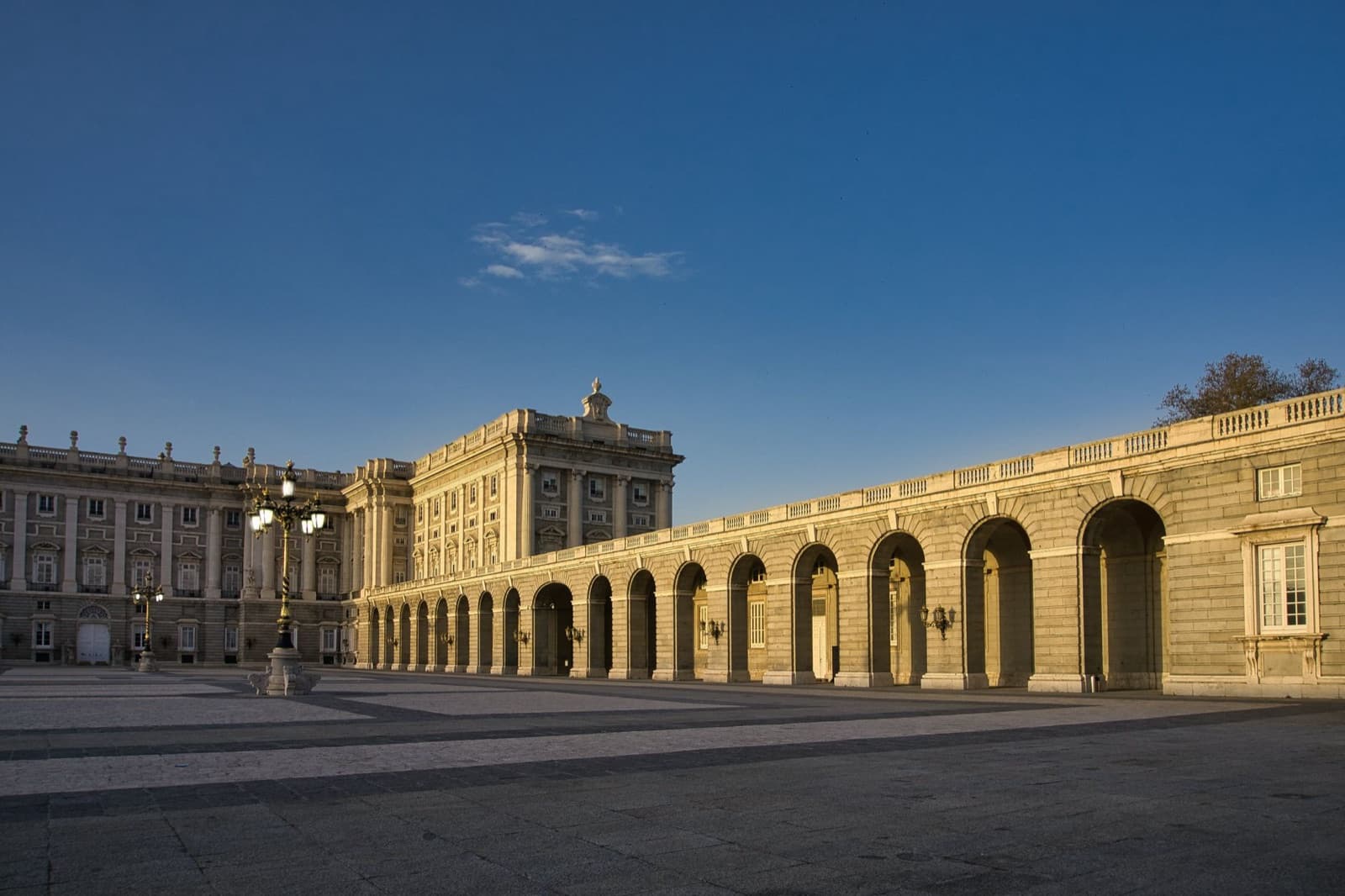 Royal Palace of Madrid: the arcaded gallery of the plaza in the evening sun