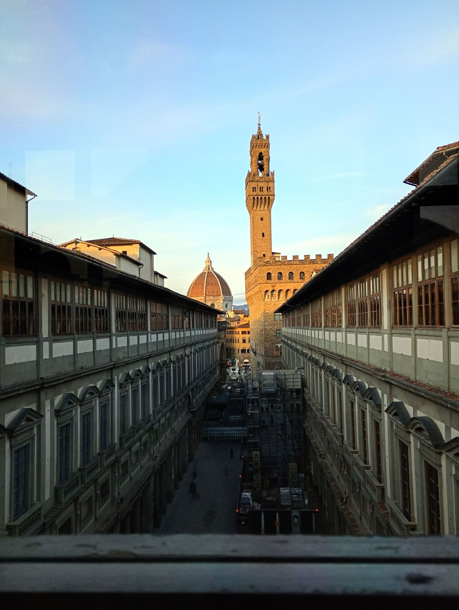 Uffizi Gallery: the Palazzo Vecchio tower and the Duomo above the courtyard, from a gallery window at the river end
